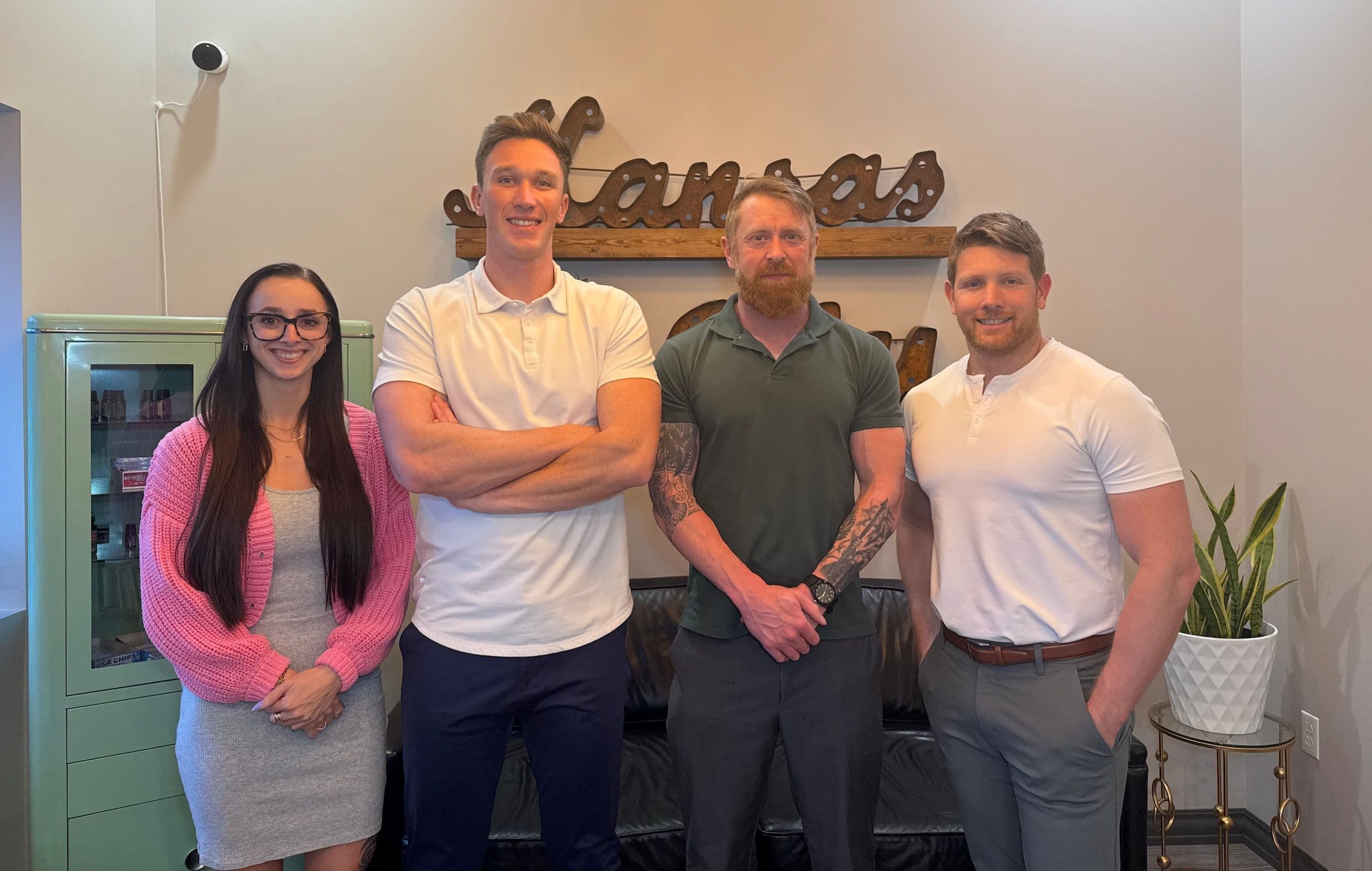 Vibrant Home Buyers team members standing together indoors.